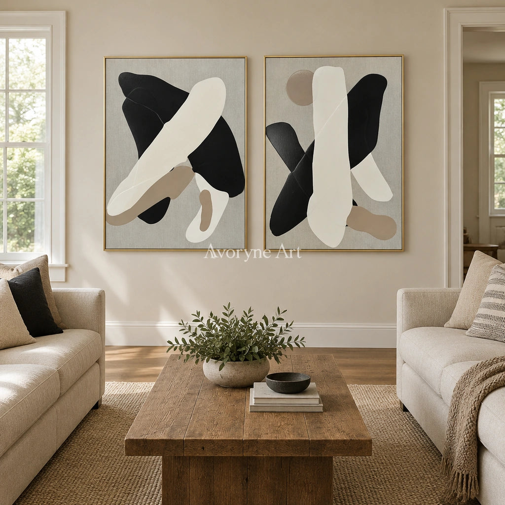 Muted Sonata black neutral organic art diptych with a gold frame hanging in a living room