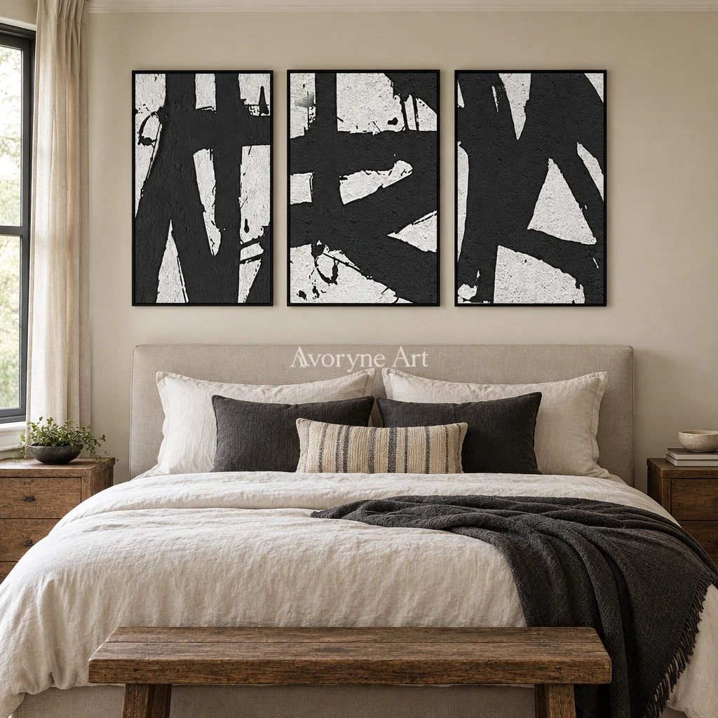 Muted Field black white brushwork triptych with a black frame above a bed in a bedroom
