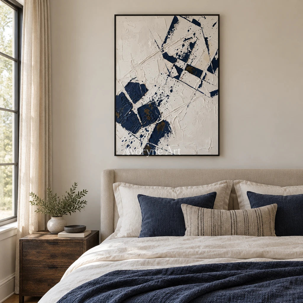 Earthen Reverie blue ivory grid wall art with a black frame above a bed in a bedroom