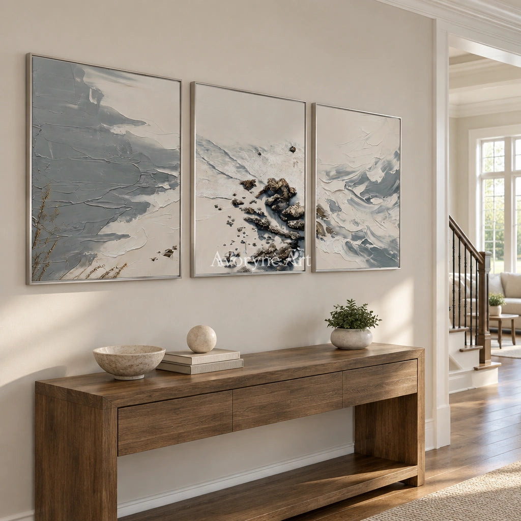 Restful Reverie coastal landscape triptych with a silver frame in an entryway