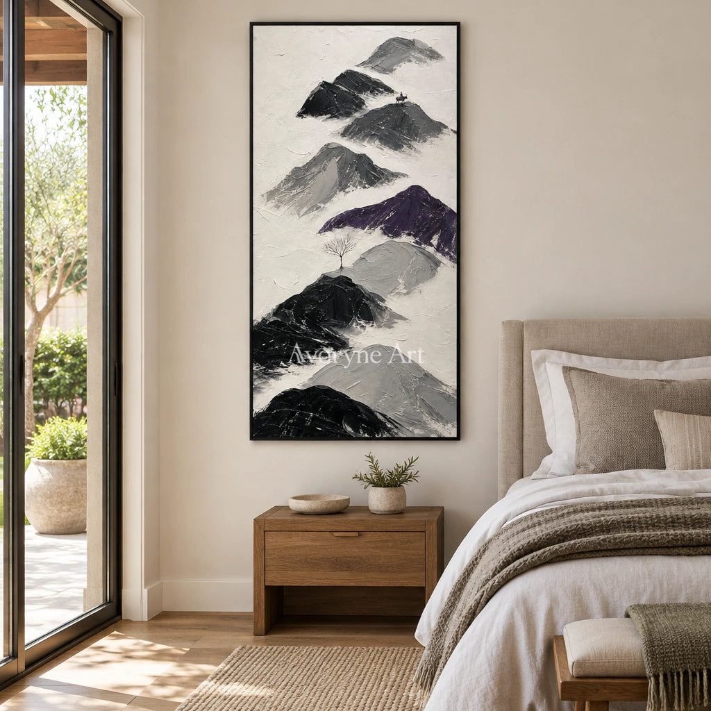Misted Echo dark mountain relief wall art with a black frame above a bed in a bedroom