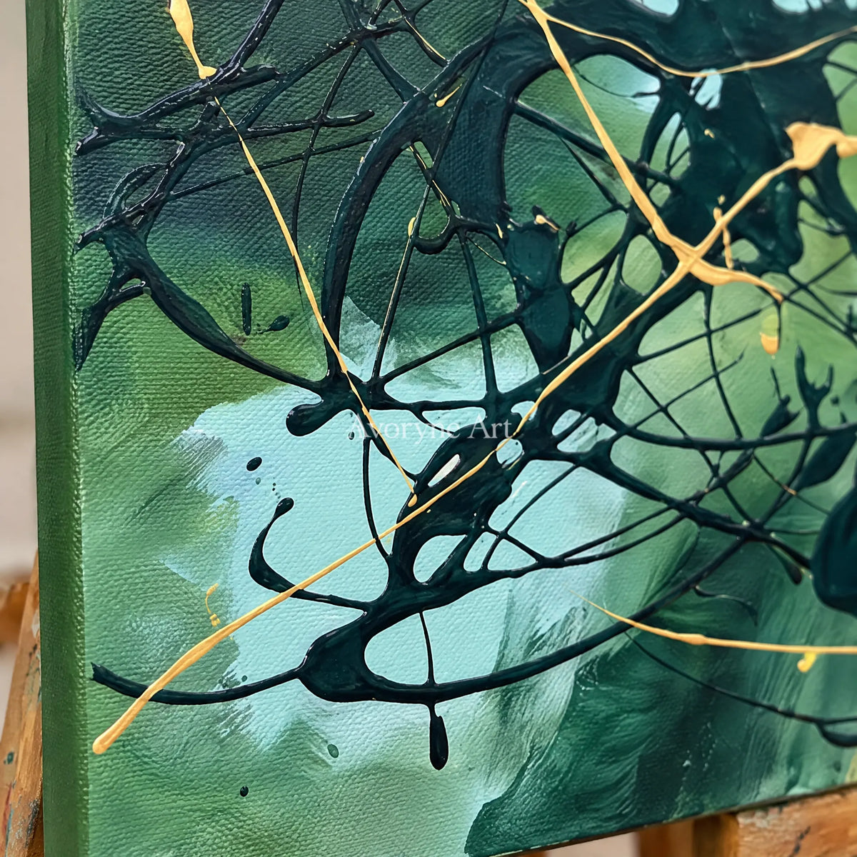 Close-up of the hand-painted texture of Golden Solace drip abstract wall art on an easel