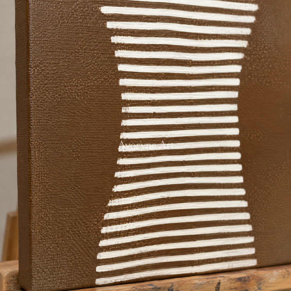 Close-up of the hand-painted texture of Muted Haven earth grooved curves diptych on an easel