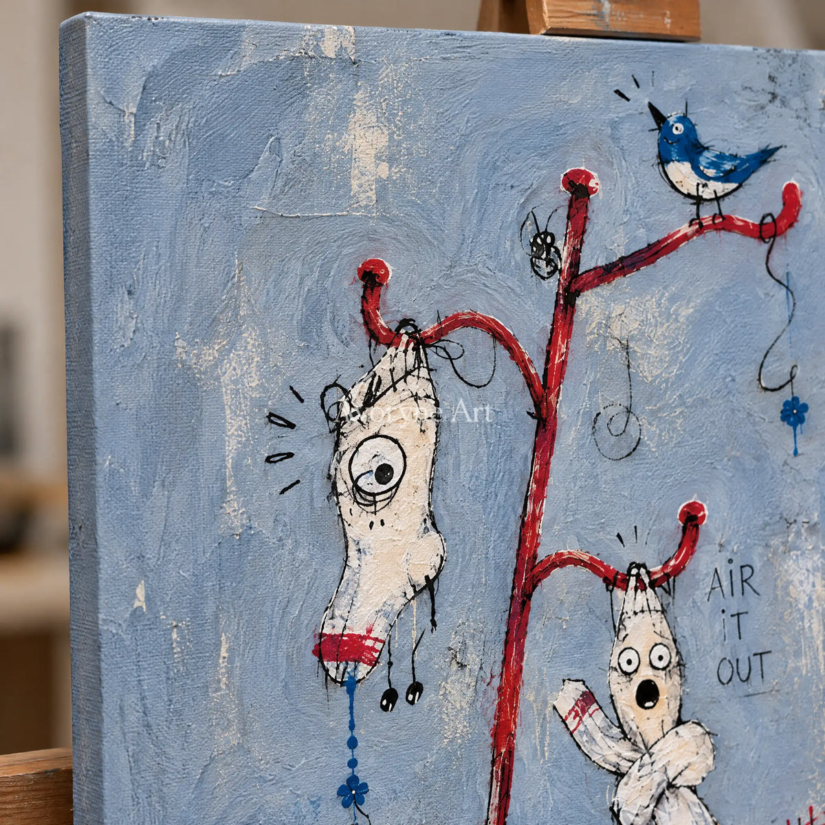 Close-up of the hand-painted texture of Open Current graffiti figure wall art on an easel