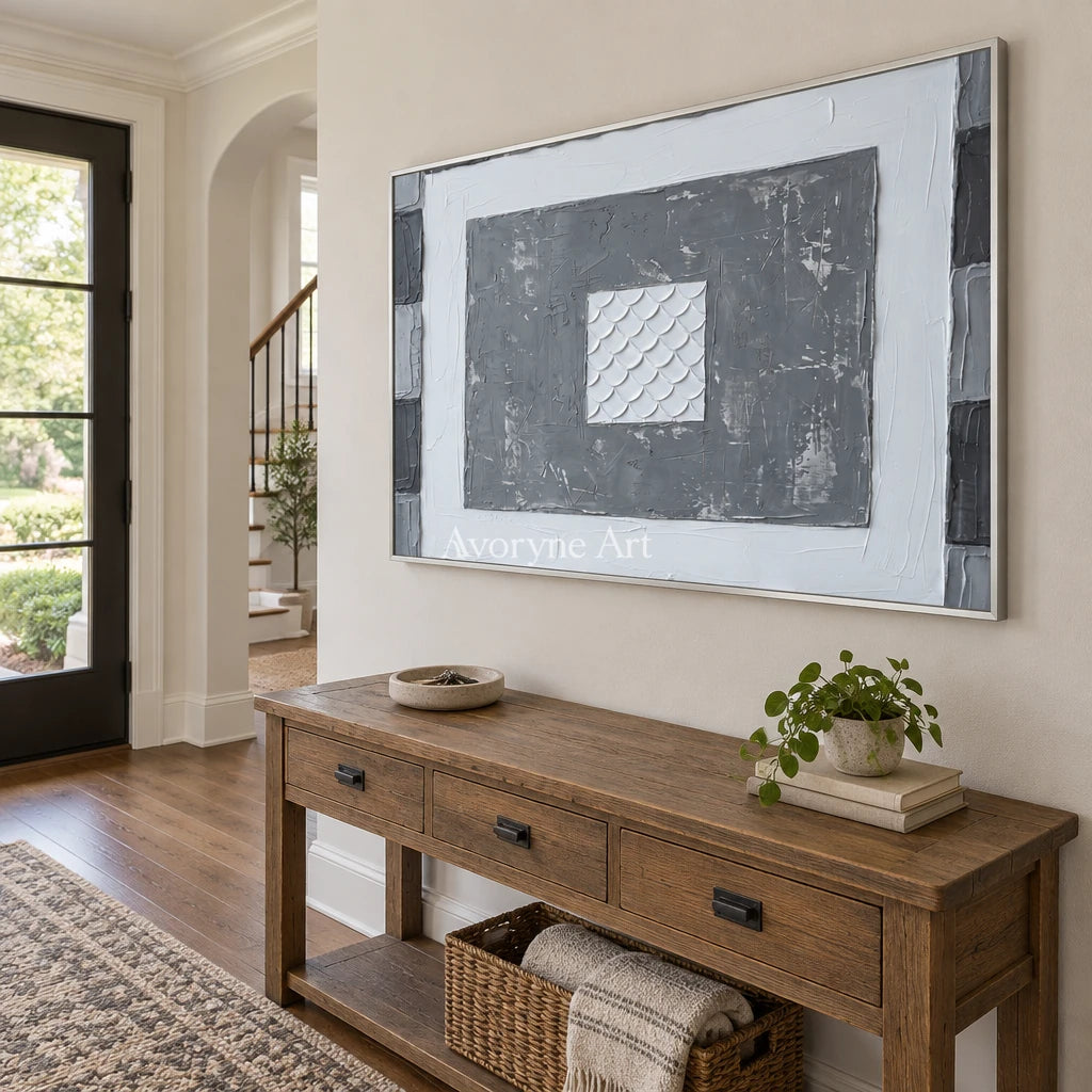 Hushed Mosaic gray scale relief wall art with a silver frame in an entryway