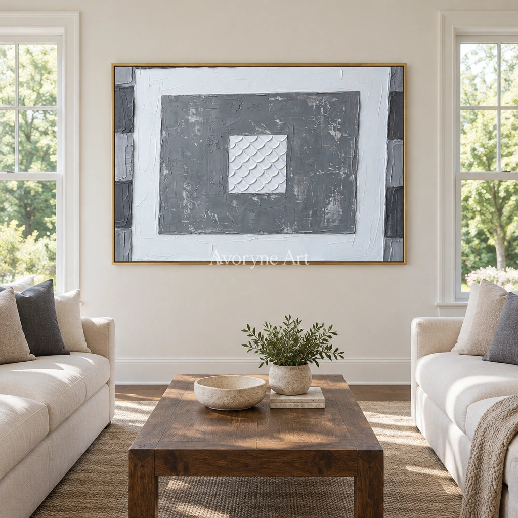 Hushed Mosaic gray scale relief wall art with a gold frame hanging in a living room