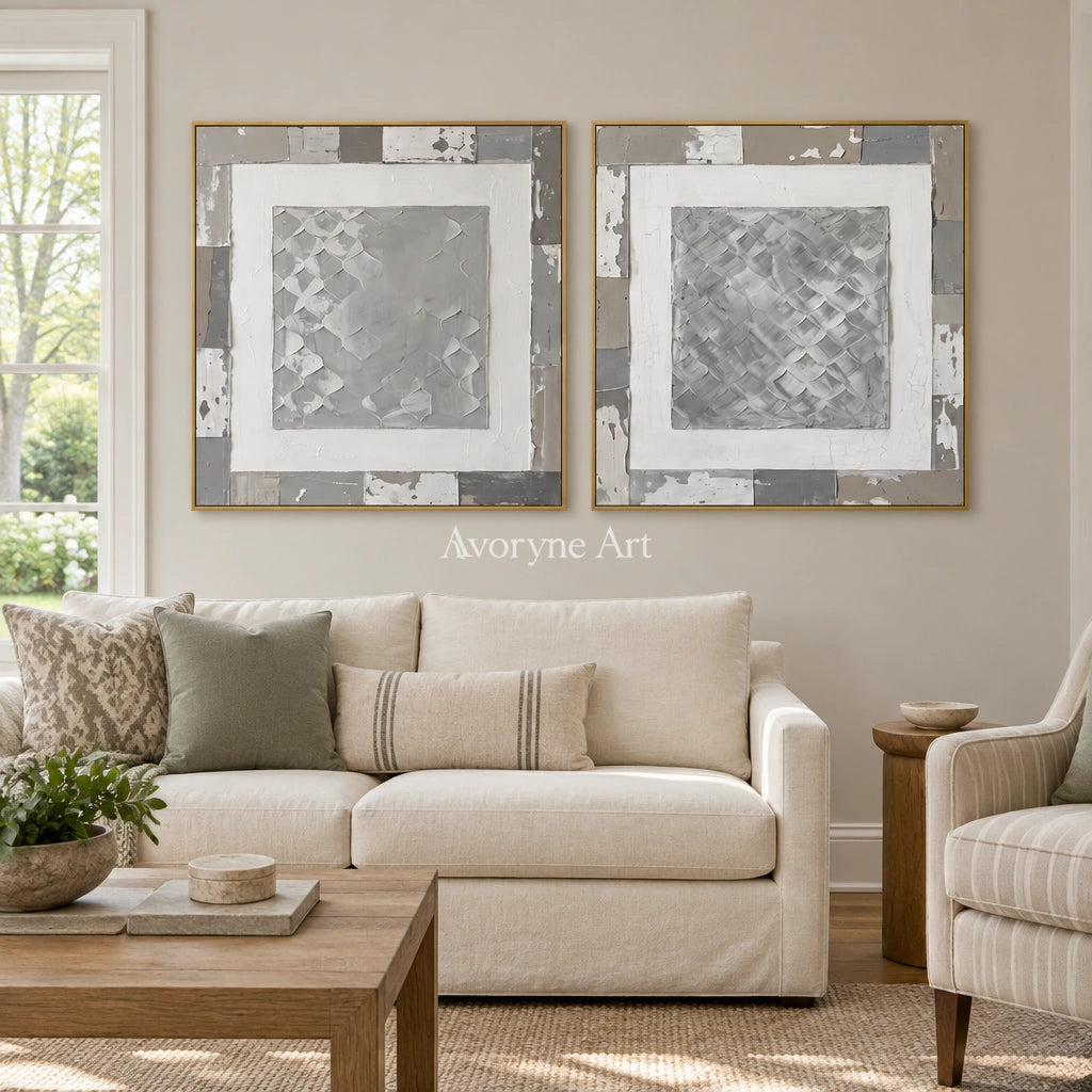 Soft Haven gray scale relief diptych with a gold frame hanging in a living room