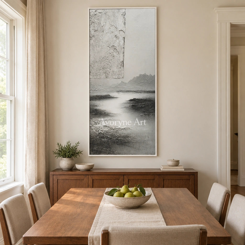 Pale Refrain gray water landscape wall art with a white frame in a dining room