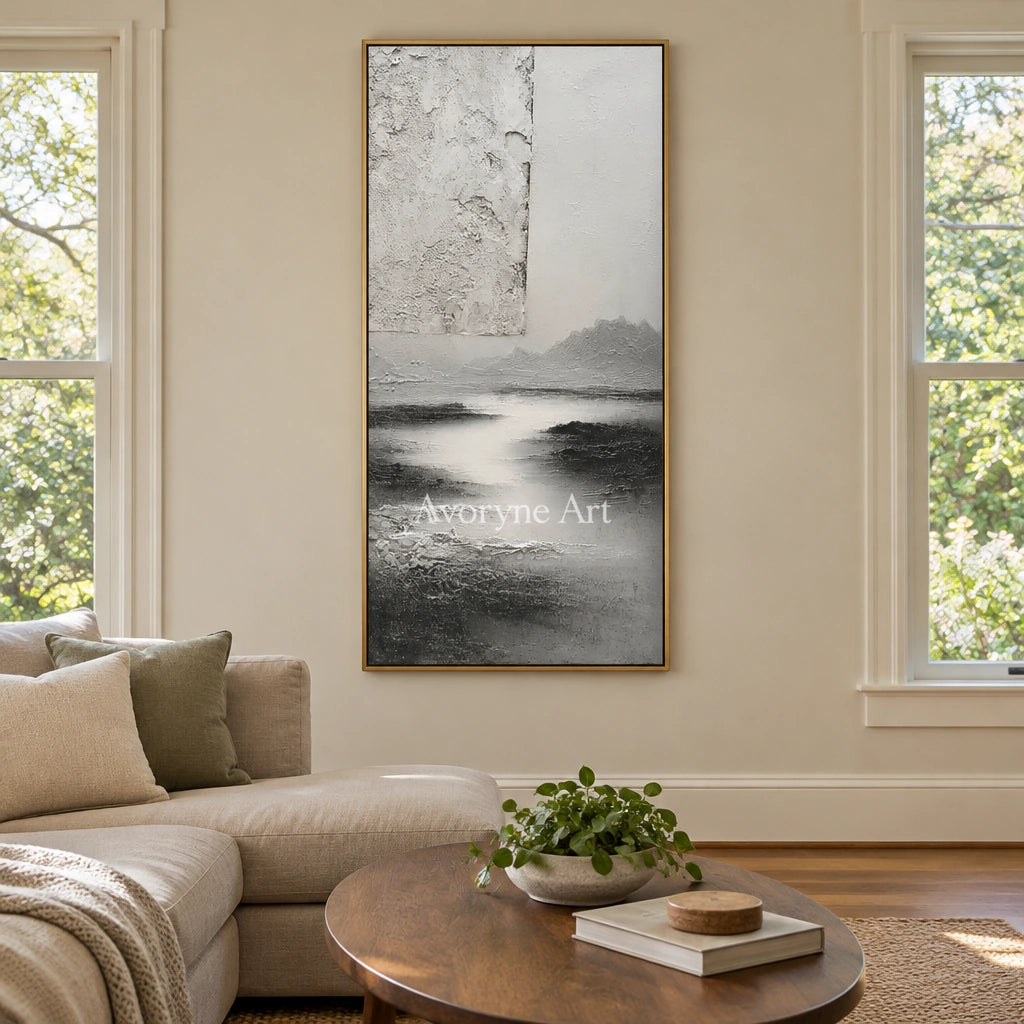 Pale Refrain gray water landscape wall art with a gold frame hanging in a living room