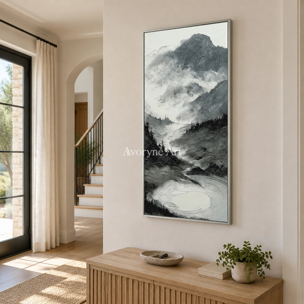 Pale Field ink mountain water wall art with a silver frame in an entryway