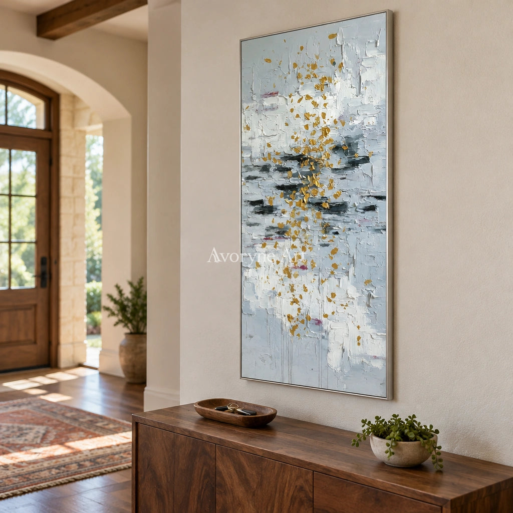 Gentle Measure ivory gold relief wall art with a silver frame in an entryway