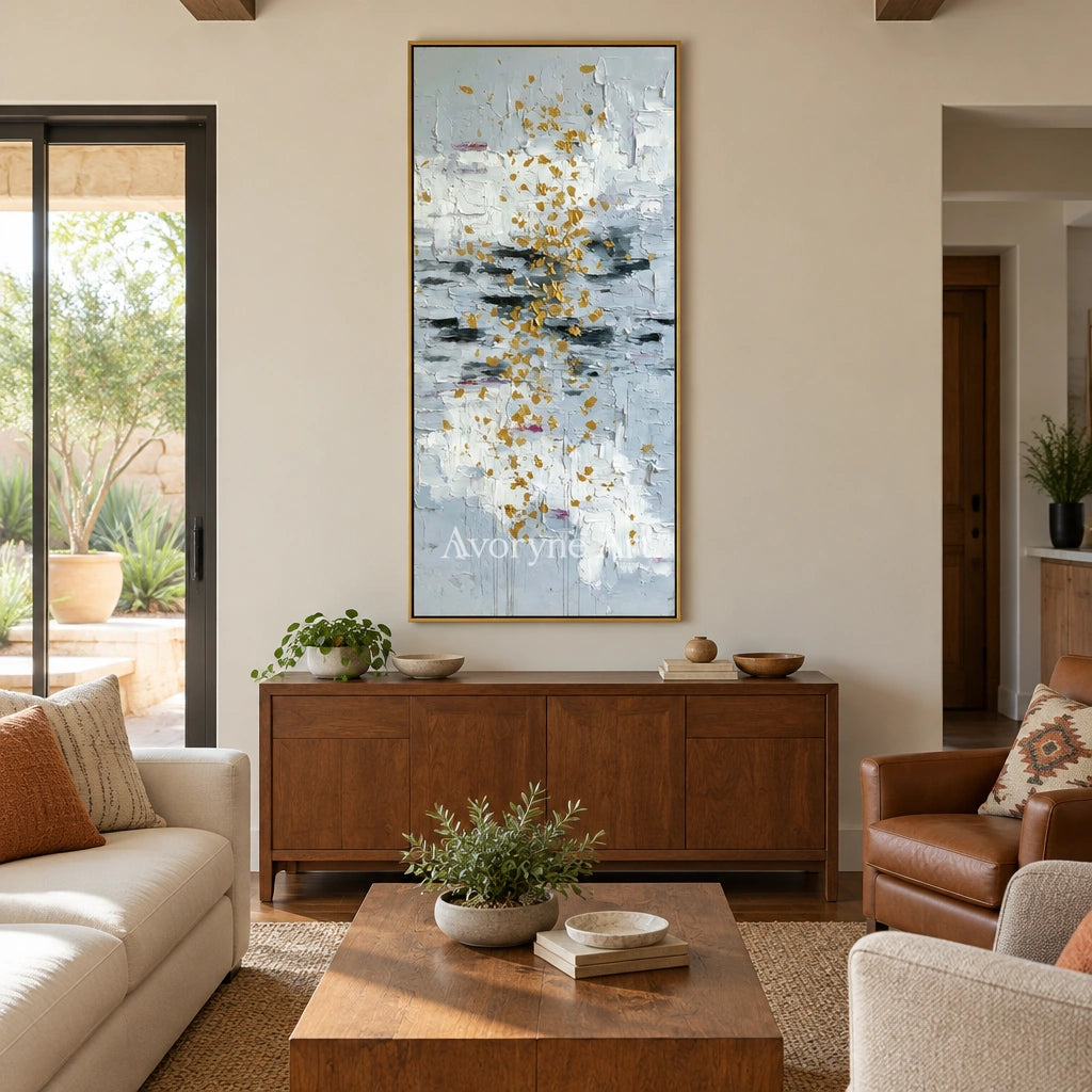 Gentle Measure ivory gold relief wall art with a gold frame hanging in a living room