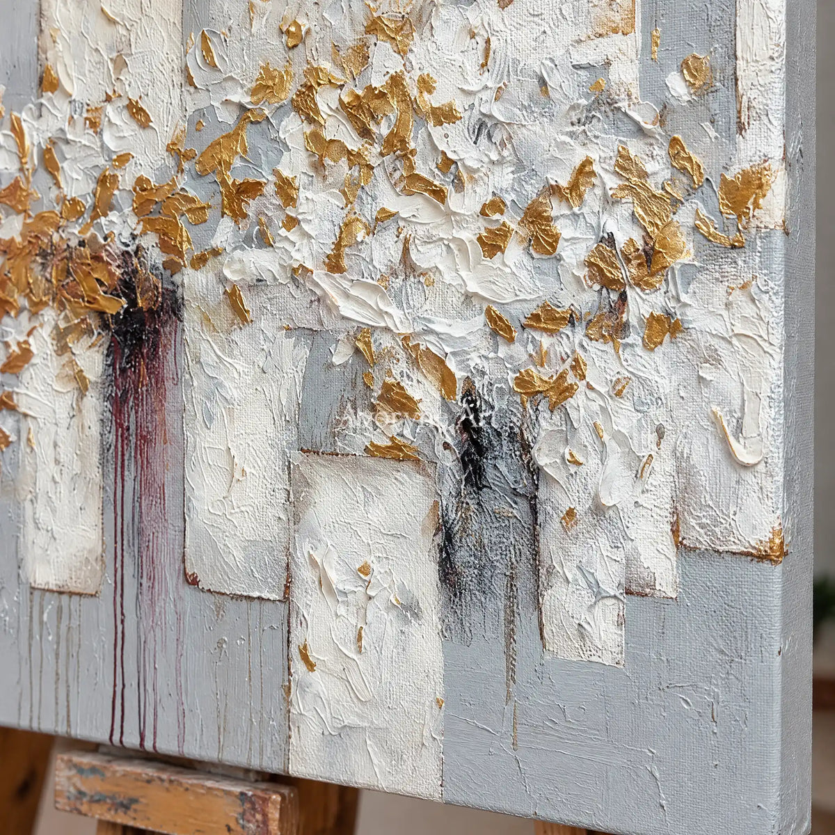 Close-up of the hand-painted texture of Gentle Field ivory gold relief wall art on an easel