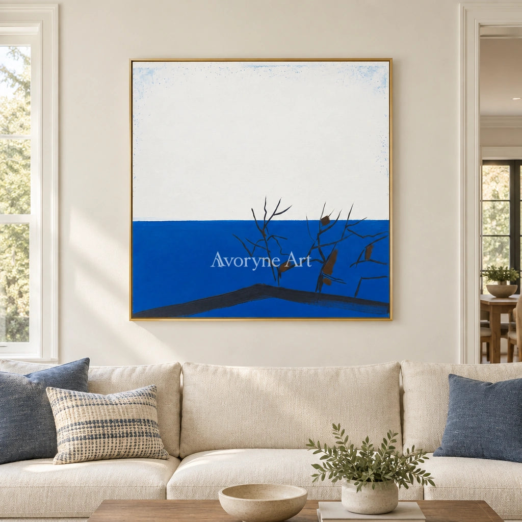 Deep Reverie minimal branch wall art with a gold frame hanging in a living room