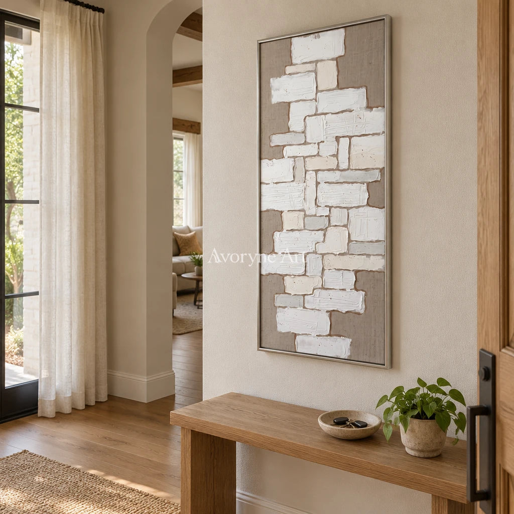 Misted Current neutral block relief wall art with a silver frame in an entryway