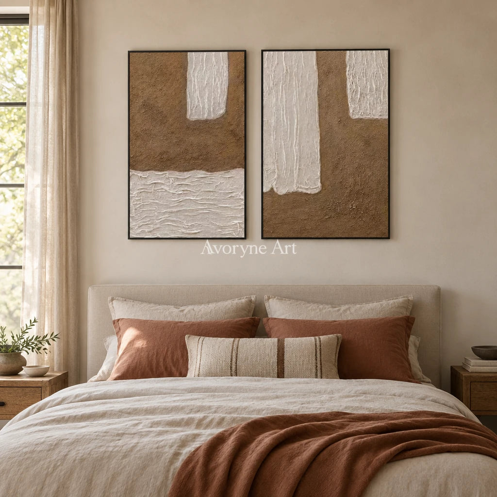 Muted Current neutral fold relief diptych with a black frame above a bed in a bedroom