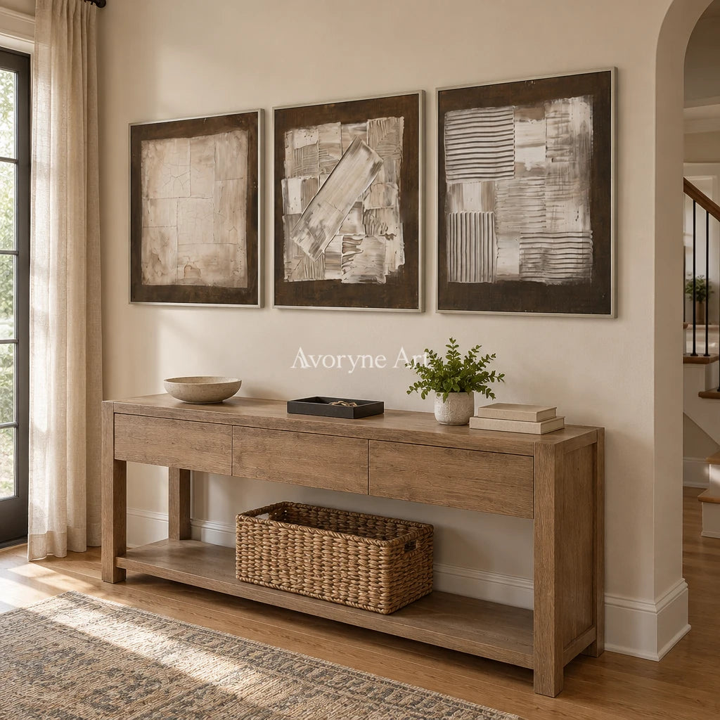 Hushed Field neutral geometric relief triptych with a silver frame in an entryway