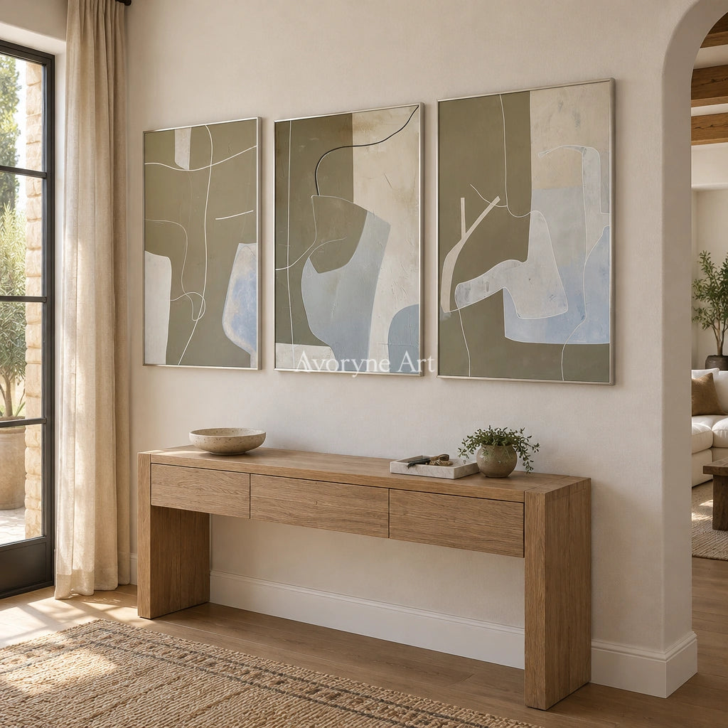Muted Passage neutral organic art triptych with a silver frame in an entryway