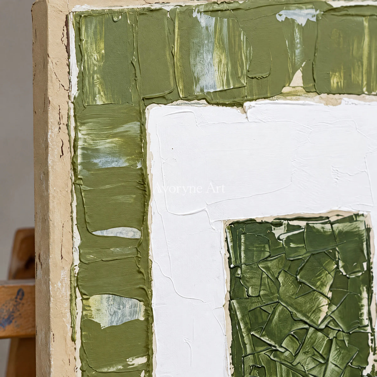Close-up of the hand-painted texture of Mineral Haven olive ivory grid wall art on an easel