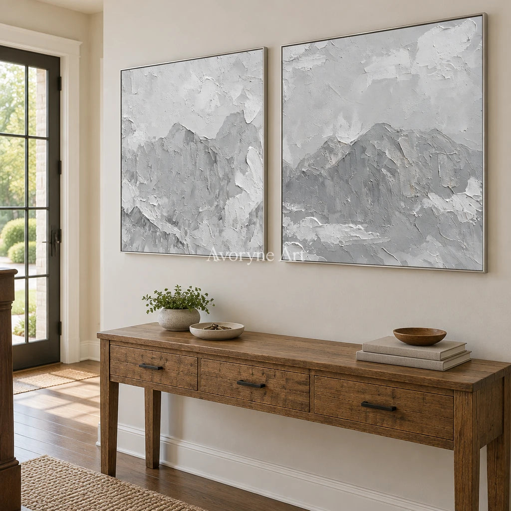Muted Memory pale mountain relief diptych with a silver frame in an entryway