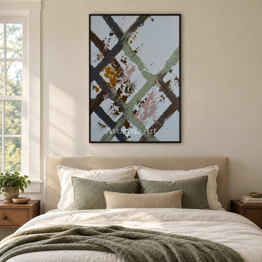 Weathered Cadence sage earth grid wall art with a black frame above a bed in a bedroom