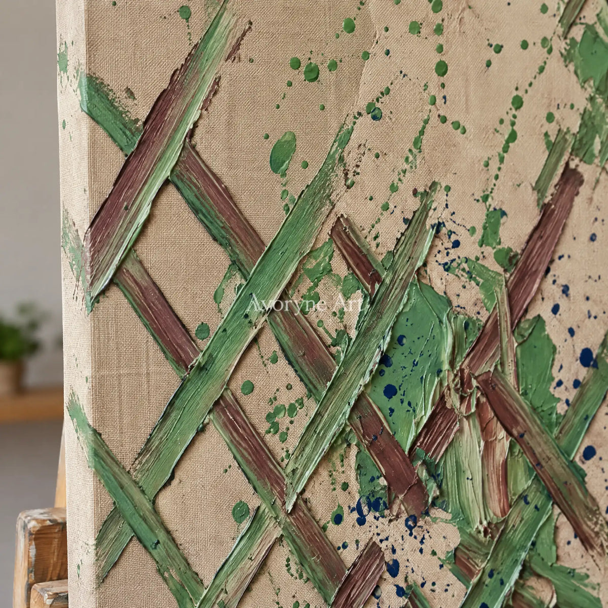 Close-up of the hand-painted texture of Earthen Trace sage earth grid wall art on an easel
