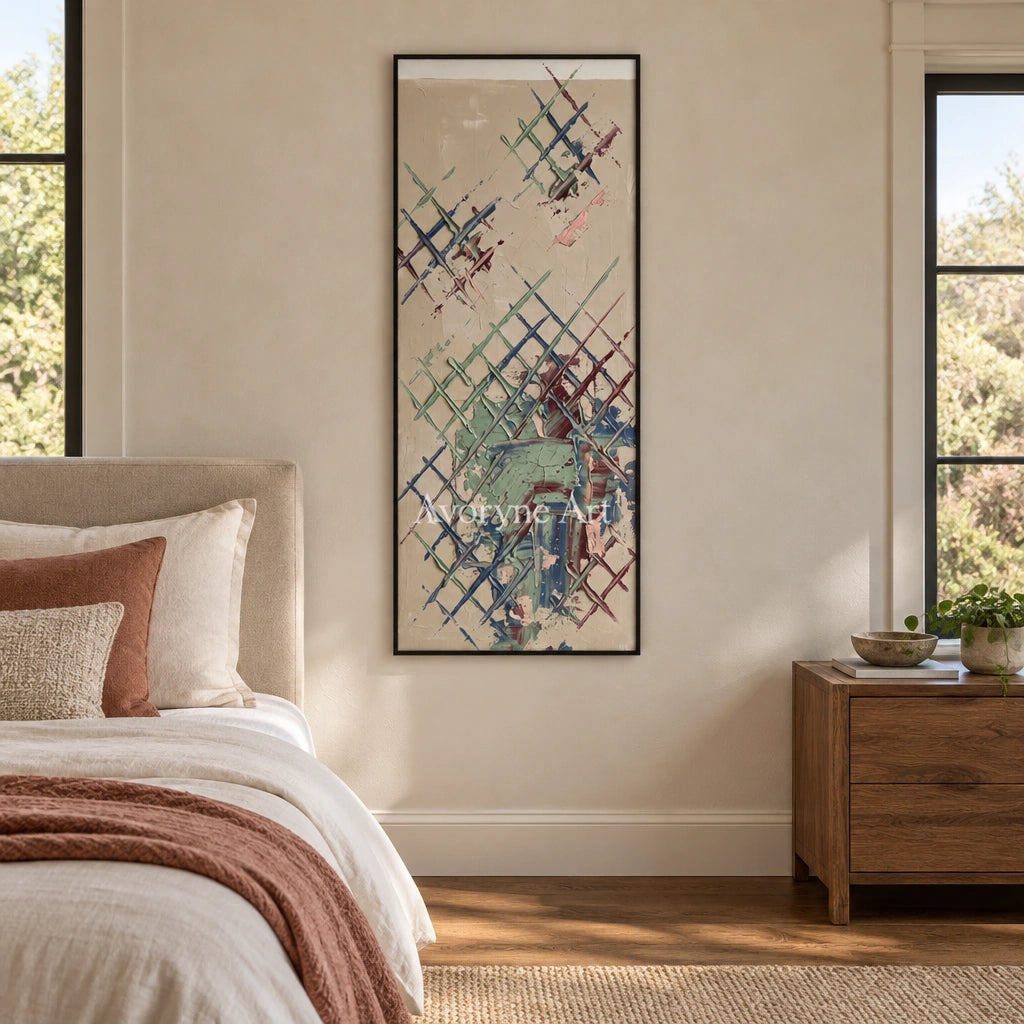 Earthen Current sage earth grid wall art with a black frame above a bed in a bedroom