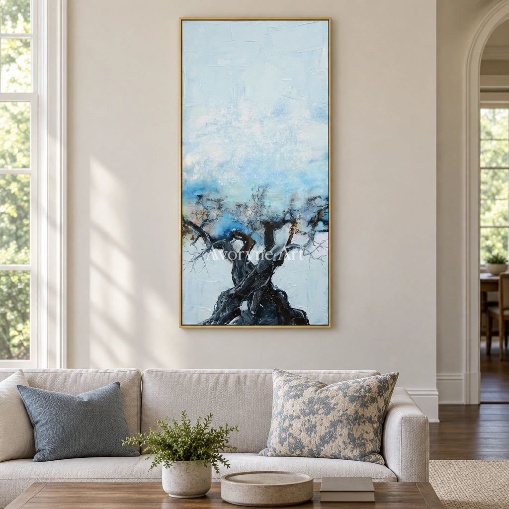 Blue Story snow branch wall art with a gold frame hanging in a living room