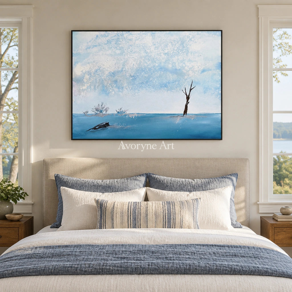 Blue Current snow branch wall art with a black frame above a bed in a bedroom