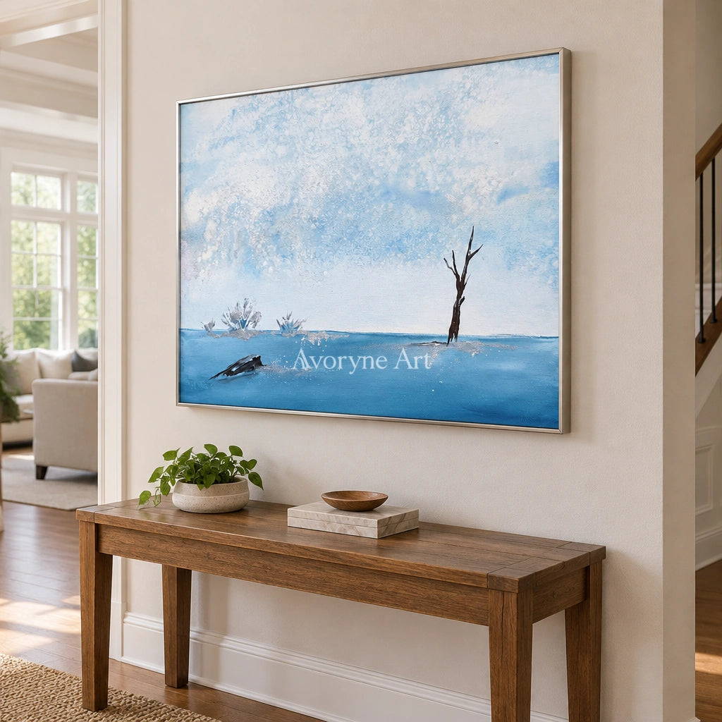 Blue Current snow branch wall art with a silver frame in an entryway