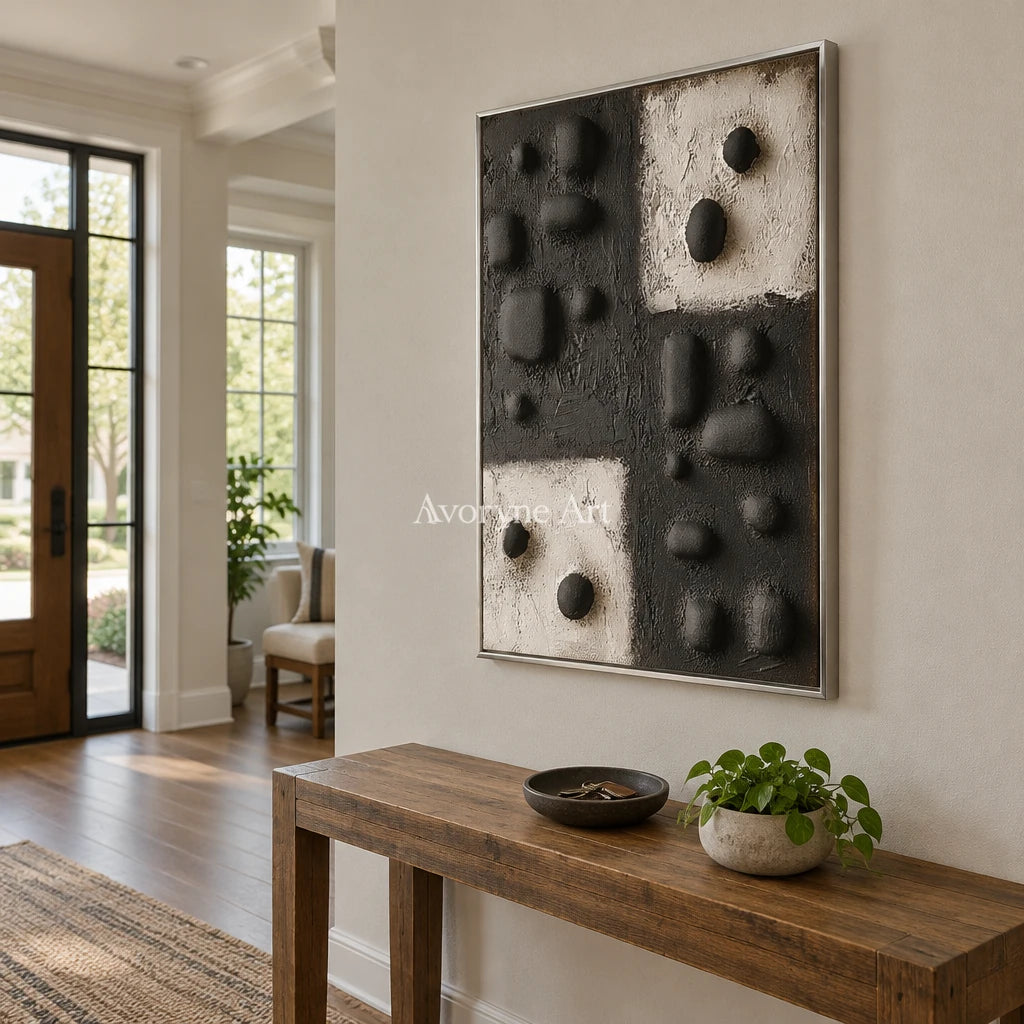 Muted Refrain stone dot relief wall art with a silver frame in an entryway