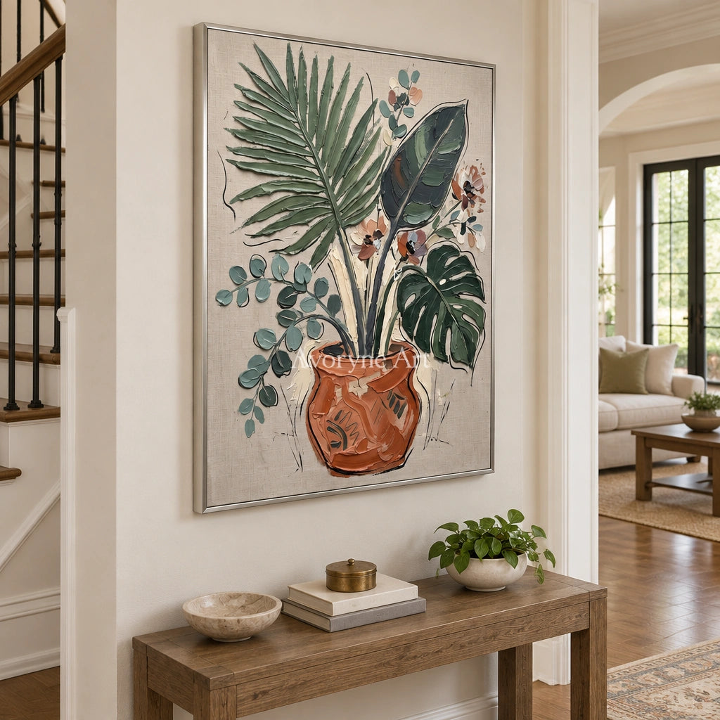 Silver Cadence vase and foliage wall art with a silver frame in an entryway
