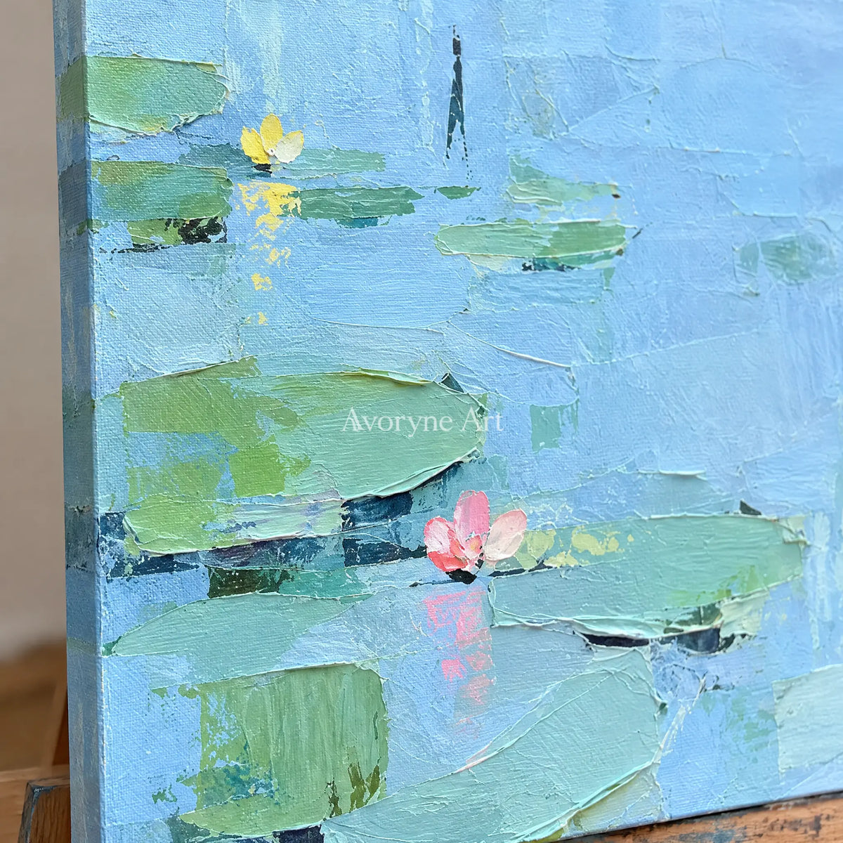 Close-up of the hand-painted texture of Tender Gesture water lily wall art on an easel