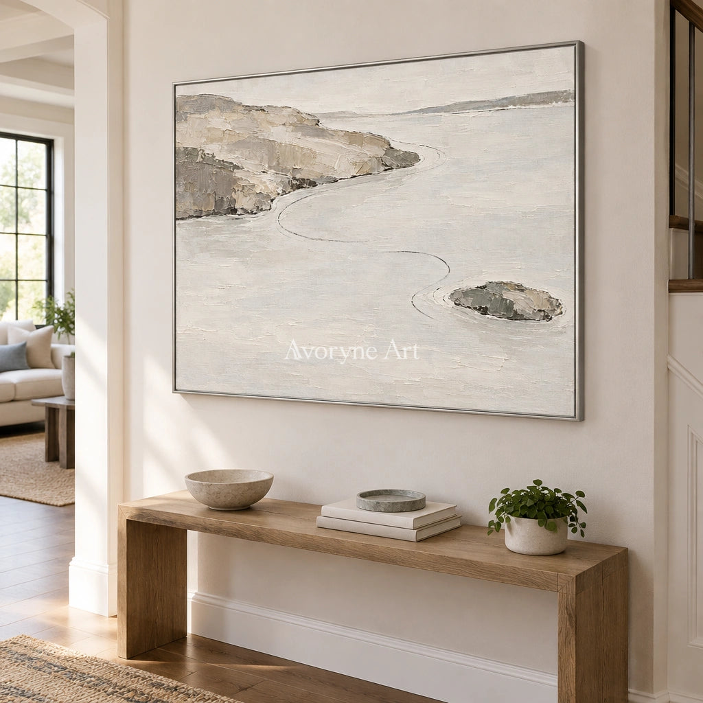 Still Solace waterside landscape wall art with a silver frame in an entryway