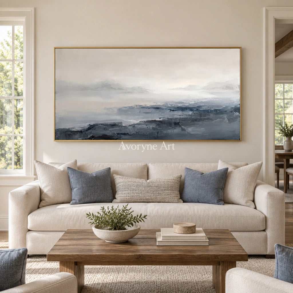 Winding Dialogue waterside landscape wall art with a gold frame hanging in a living room