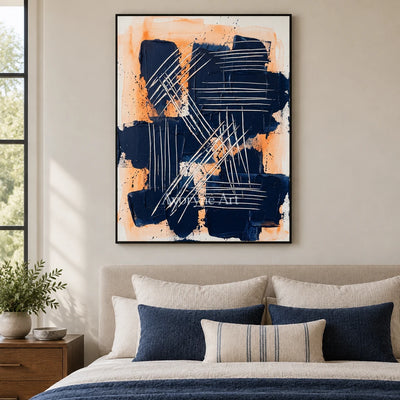 Silver Current abstract brushwork wall art with a black frame above a bed in a bedroom