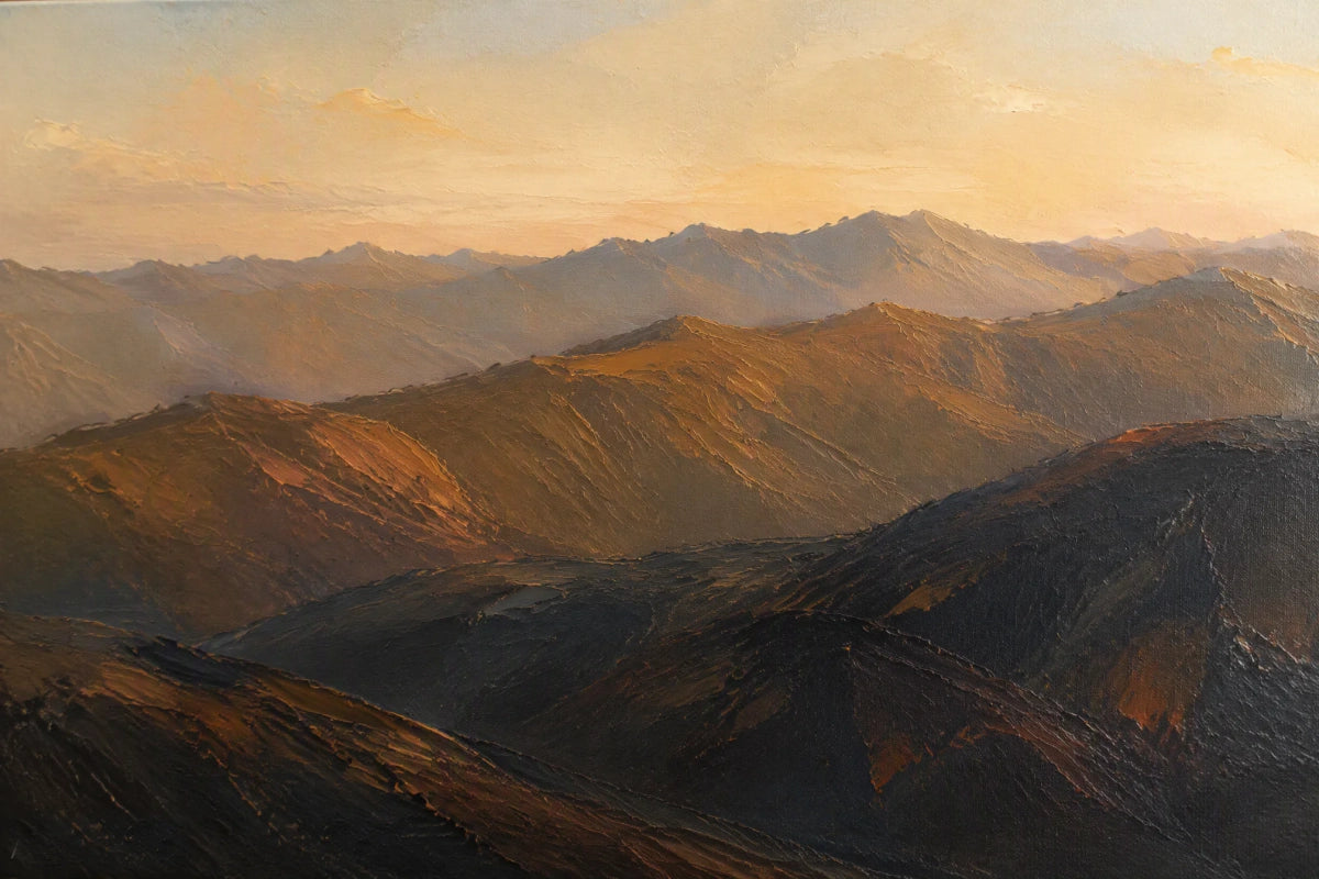 Layered mountain ridges in warm evening light