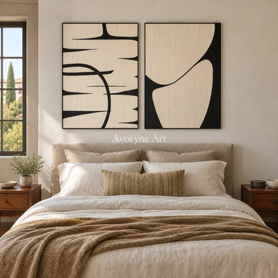 Muted Trace black ivory line art diptych with a black frame above a bed in a bedroom