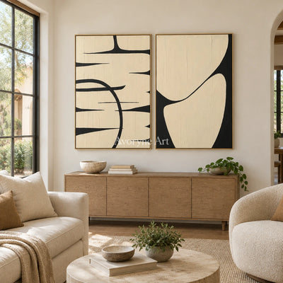 Muted Trace black ivory line art diptych with a gold frame hanging in a living room