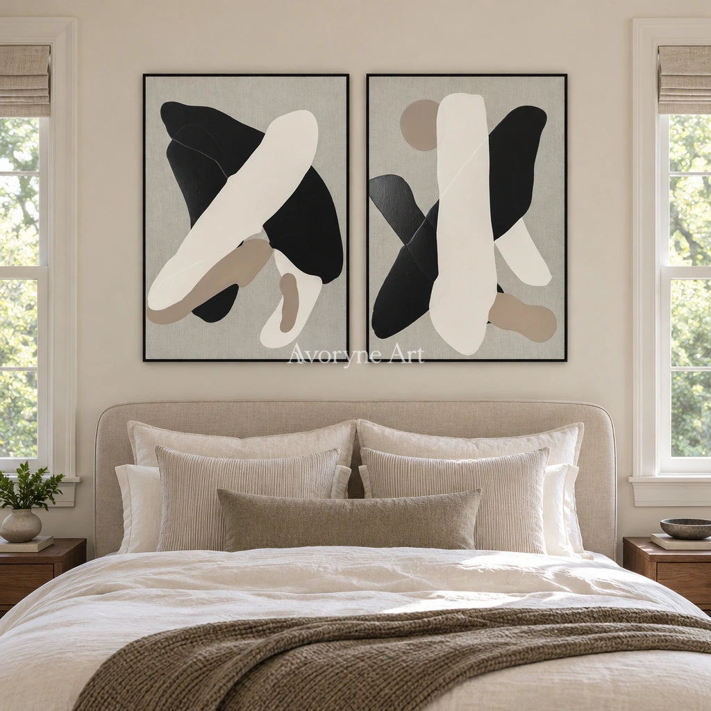 Muted Sonata black neutral organic art diptych with a black frame above a bed in a bedroom