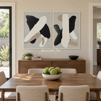 Muted Sonata black neutral organic art diptych with a white frame in a dining room