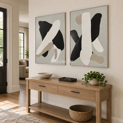 Muted Sonata black neutral organic art diptych with a silver frame in an entryway