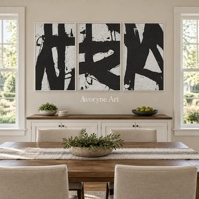 Muted Field black white brushwork triptych with a white frame in a dining room