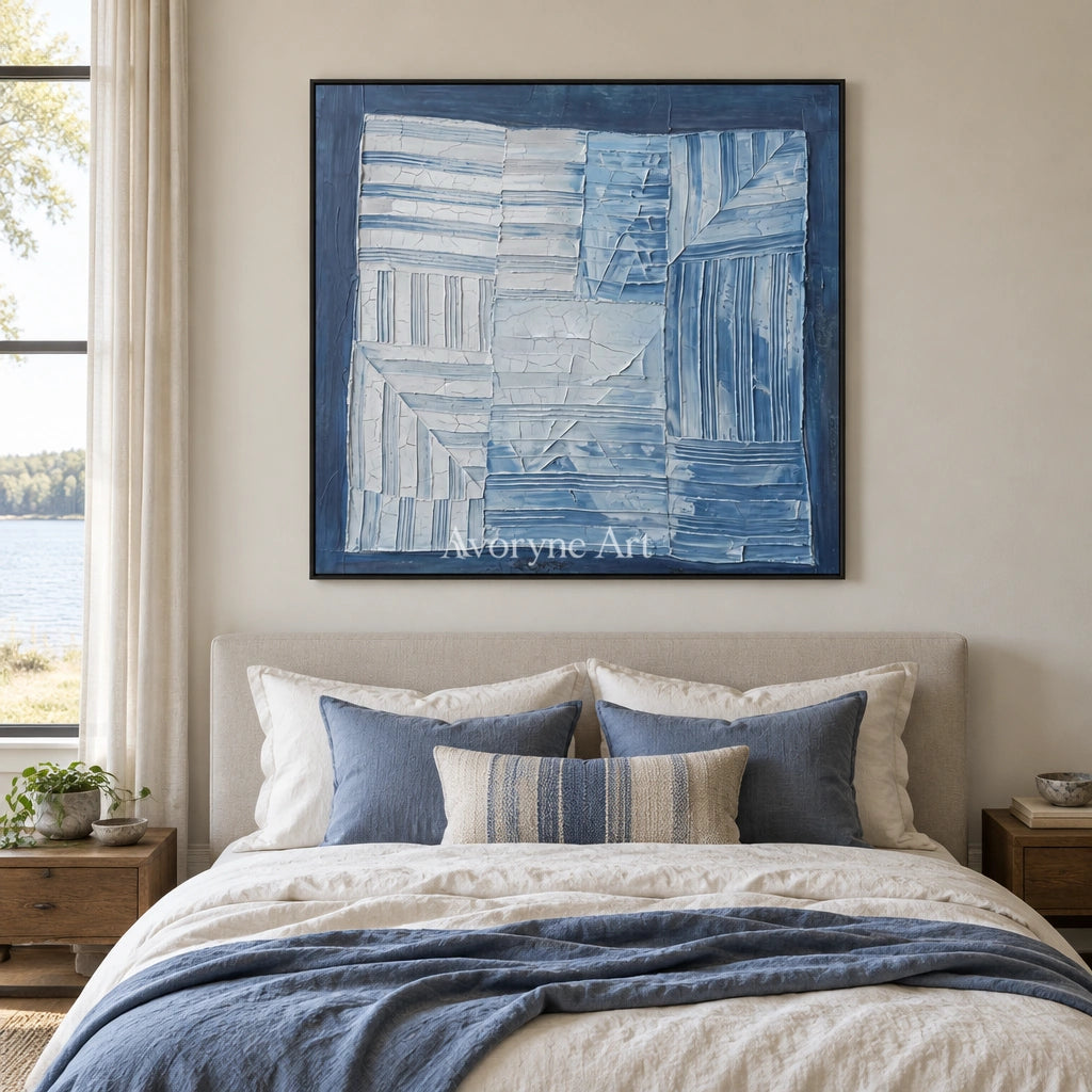 Earthen Solace blue geometric texture wall art with a black frame above a bed in a bedroom