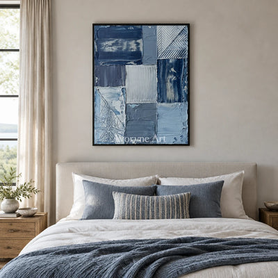 Hushed Measure blue geometric texture wall art with a black frame above a bed in a bedroom