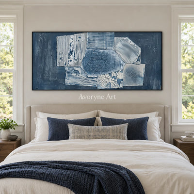 Mineral Passage blue geometric texture wall art with a black frame above a bed in a bedroom