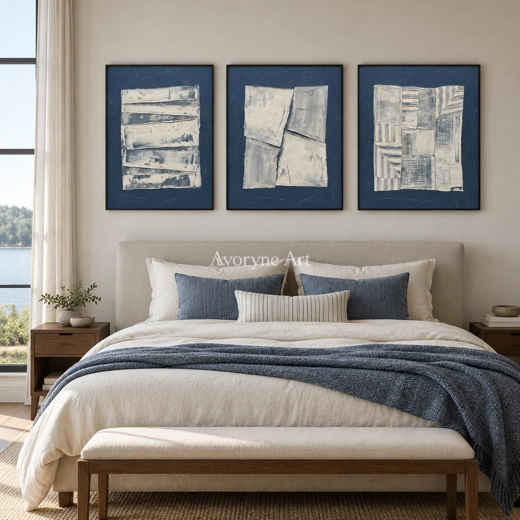 Hushed Solace blue geometric texture triptych with a black frame above a bed in a bedroom