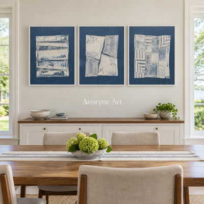 Hushed Solace blue geometric texture triptych with a white frame in a dining room