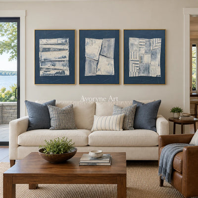Hushed Solace blue geometric texture triptych with a gold frame hanging in a living room