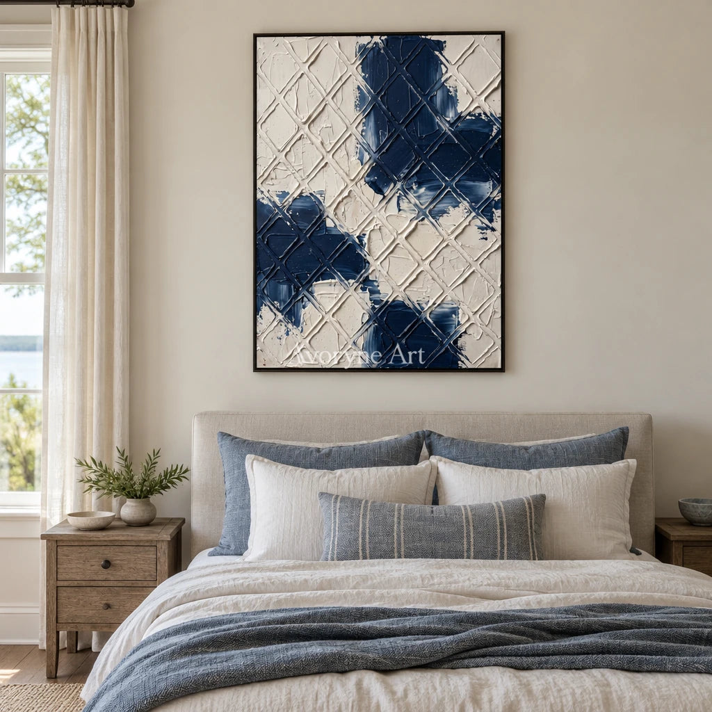Weathered Current blue ivory grid wall art with a black frame above a bed in a bedroom